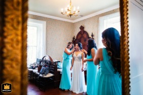 The bride gets ready with her bridesmaids inside Elliston Vineyards in Sunol, California, as they help with final preparations